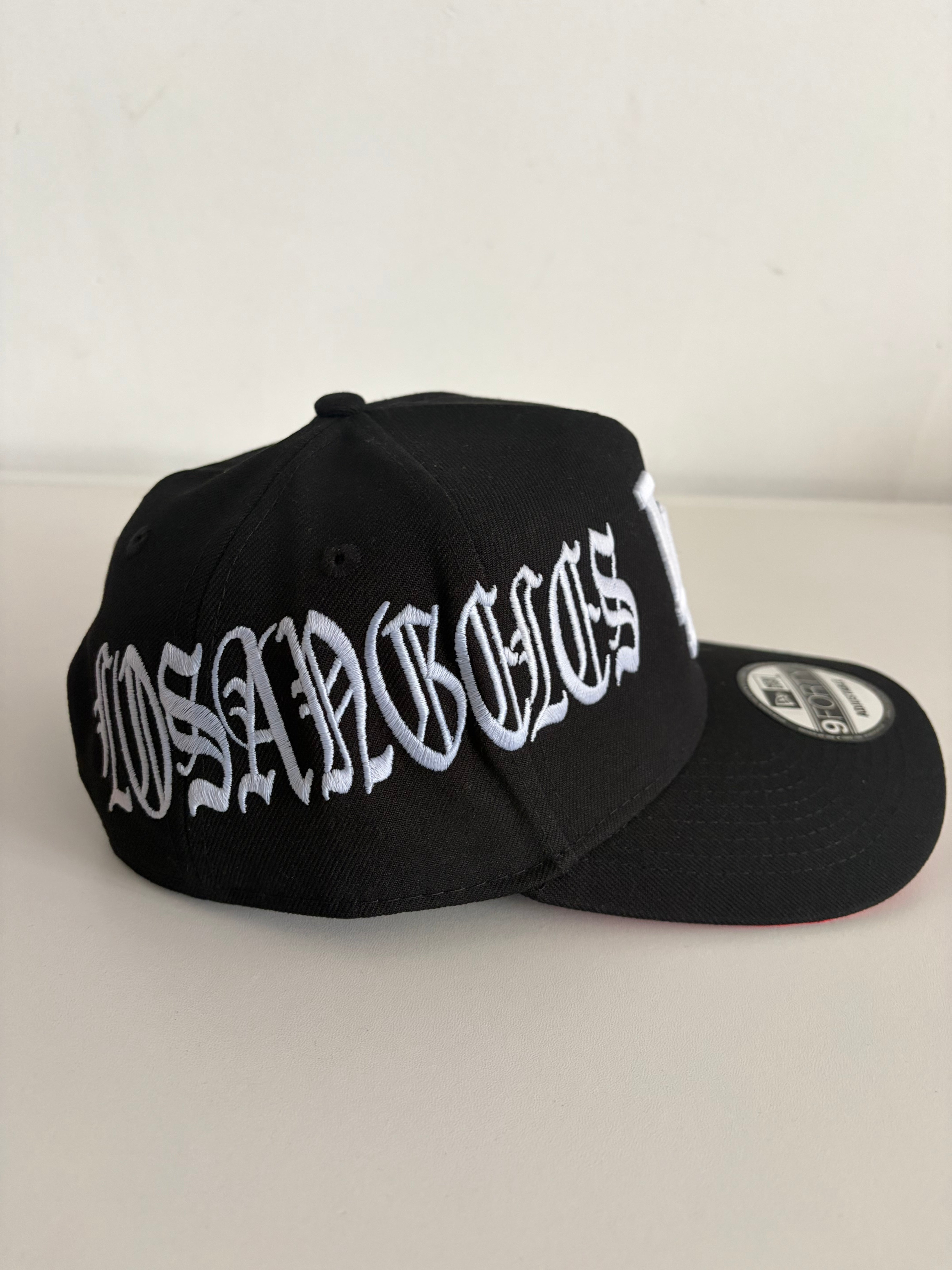 New Era LA Dodgers Old English Script 9FORTY cap in black and white, back view